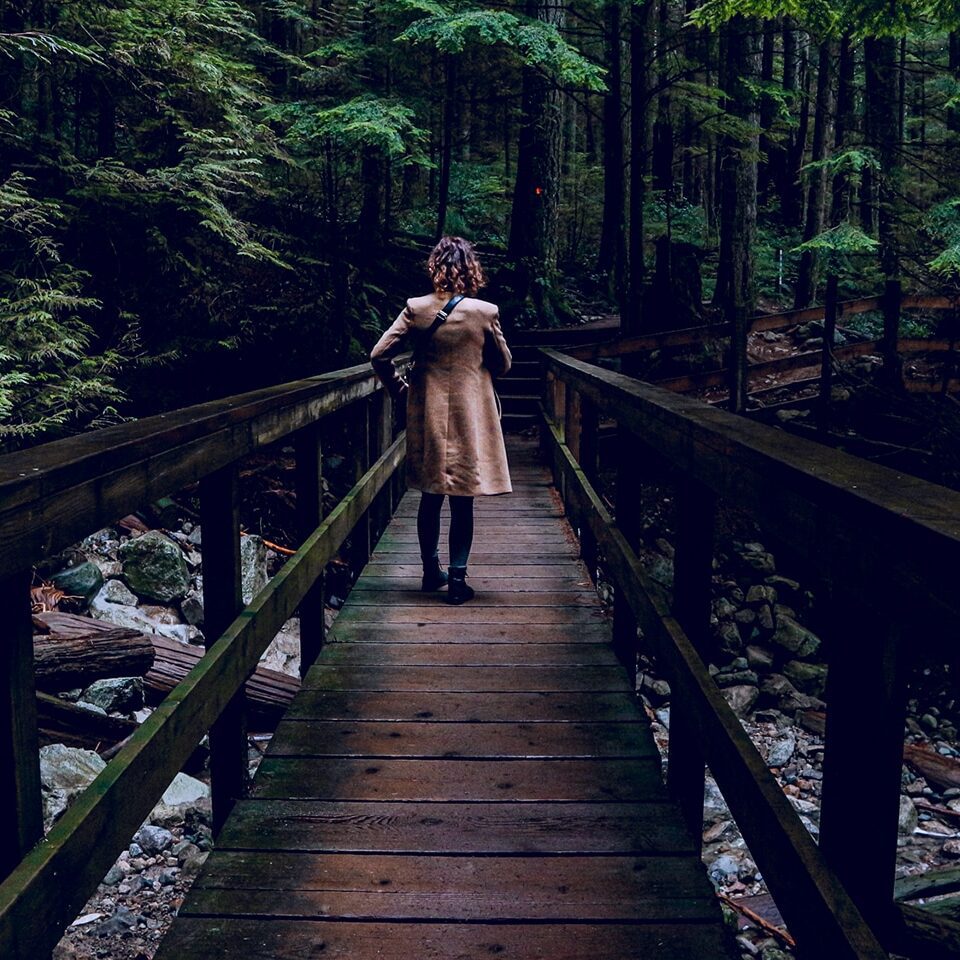 Indira on a bridge in the forest of Lynn Valley in North Vancouver